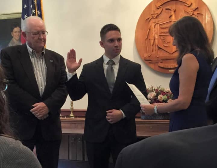 Weston&#x27;s newest police officer Jon Marsili is sworn in by First Selectman Gayle Weinstein, right, during a ceremony with Police Commission Chairman Bill Brady.