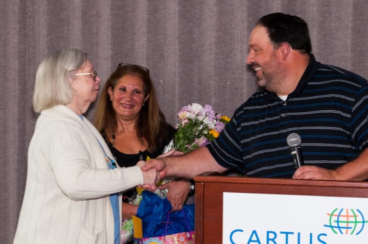 Judy Jensen is congratulated for 50 years of service at Cartus by Dan Fisher, director of operations accounting, and Anat Schneider, manager of Client Finance, Corp F&amp;A, on her big day.