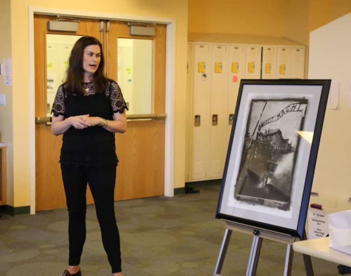 Julia Gilbert of Greenwich displayed her father&#x27;s photography of Auschwitz and other concentration camps during her recent presentation on the Holocaust at Sacred Heart in Greenwich.