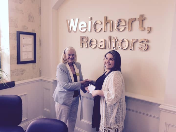 Sara J. Brine, manager of Weichert Realtor&#x27;s Closter office, presents the award to Kelsey Stewart.