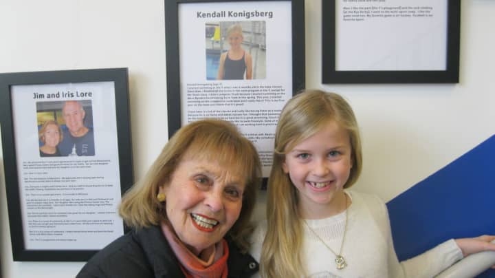 Kendall Konigsberg with her grandmother at the Rye YMCA. 
They are standing in front of her story, part of the 2015 exhibit on display through Feb. 15. Members of the public are welcome to stop by to view the stories at the YMCA at 21 Locust Ave.