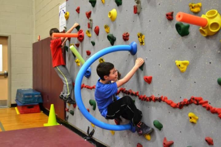 Kenisco School students rock-climb for the school&#x27;s annual Jump Rope for Heart event.