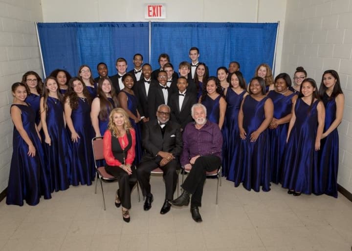 Kenny Rogers, sitting on the right, and the New Rochelle High School PAVE singers.