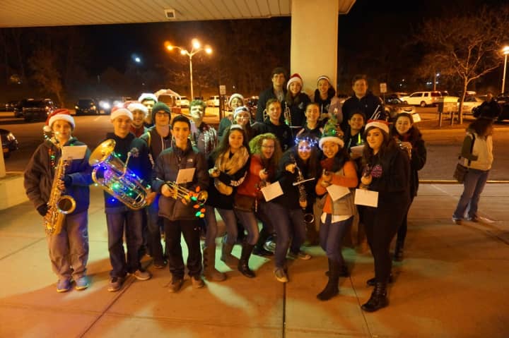 Members of the Yorktown High School band delighted onlookers recently with their playing and caroling at the town&#x27;s annual Holiday Electric Lights Parade.