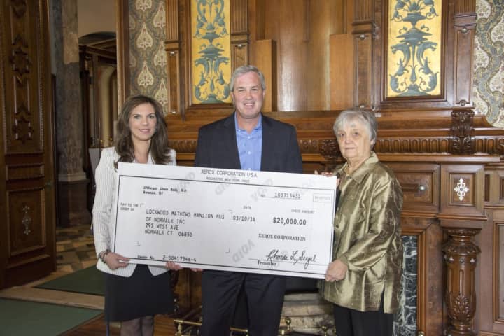 Lockwood-Mathews Mansion Museum Executive Director Susan Gilgore, The Xerox Foundation President Mark Conlin and Patsy Brescia, chairman of the museum&#x27;s board of trustees .