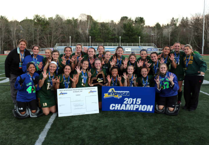 The Lakeland High School field hockey team poses with its title banner.