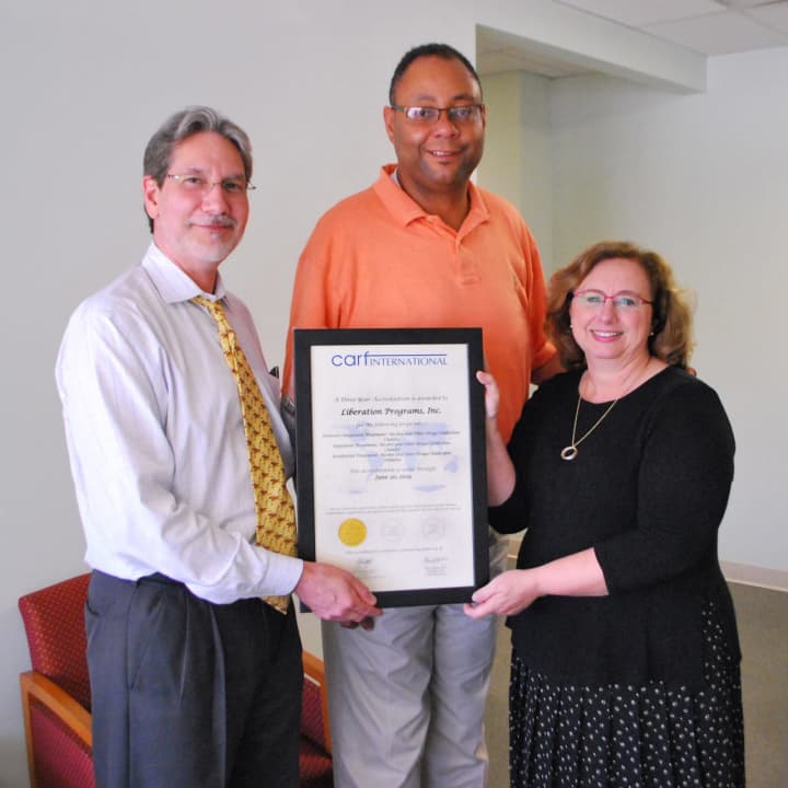 Liberation Programs&#x27; Cary Ostrow, chief administrative officer; Alan Mathis, president and CEO; and Dr. Patti Juliana, chief program officer, display three-year certification from CARF International.