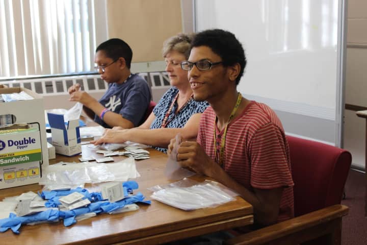 Ossining High School Life Skills students are shown at work in a summer program.