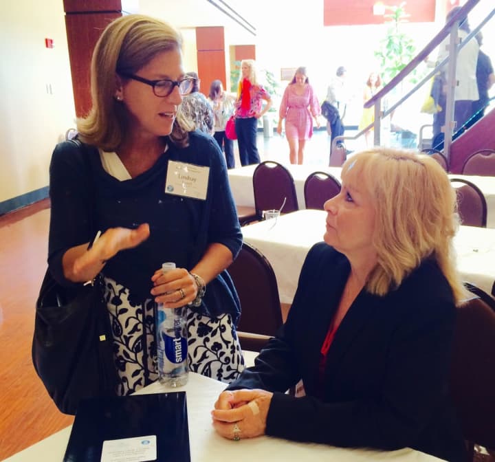 Lindsay Farrell, left, Open Door president and chief executive officer, and Diane Russo, executive director of Putnam Family &amp; Community Services, discuss developments at the Putnam County Public Health Summit.