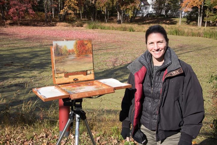 Liron Sissman painting on Bedford Road in Bedford, N.Y. Her work is on exhibit at the Pomona Cultural Center. 