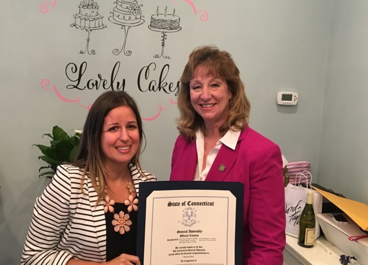 Lovely Cakes owner/chef Renata Papadopoulos, left, with a citation given to her by state Rep. Laura Hoydick on the occasion of Lovely Cakes&#x27; grand opening Nov. 7.