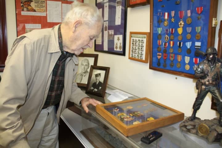Retired Navy Lt. Richard Hopkins, a World War II veteran, looks over artifacts at the Putnam Veterans Museum.