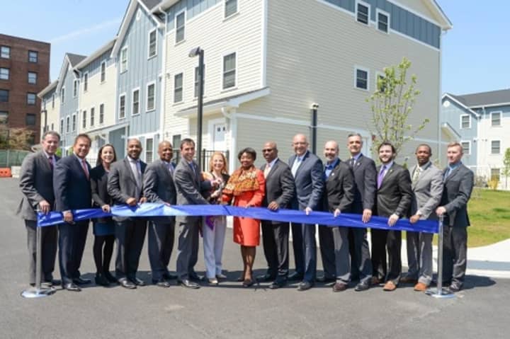 State, city and county officials cut the ribbon at the official opening of Phase II of the Heritage Homes housing development in New Rochelle this week.