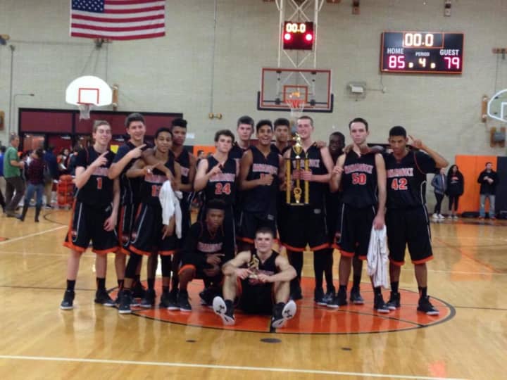 The Mamaroneck Tigers boys&#x27; basketball team pose with the Tigers Tournament trophy.