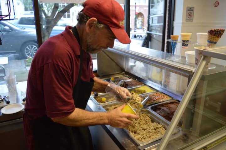 Marc Silverberg scoops cookie dough in his shop on Rock Road.