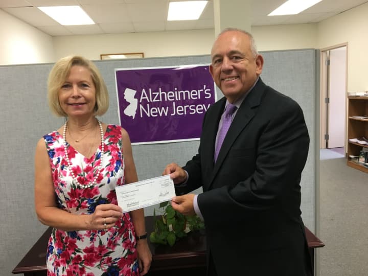 Jeffrey Duncan presented a $5,000 check to Elaine Winter, the associate director of Alzheimer&#x27;s N.J.&#x27;s Northern Regional office in Oradell.