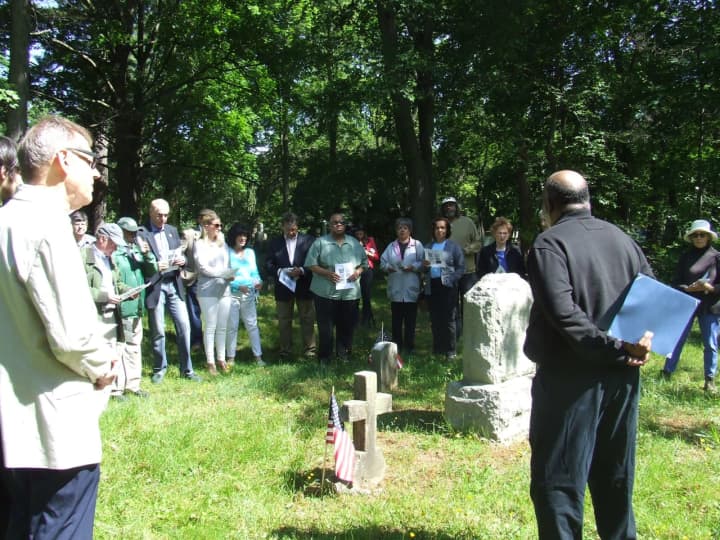 David Thomas  addresses the group of people who gathered to remember members of the 29th Connecticut Volunteer Regiment and other veterans buried at the African American Cemetery located within Greenwood Union Cemetery in Rye.