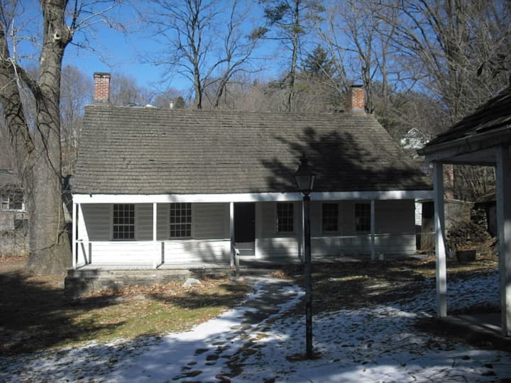 The Miller House, once used by George Washington as a headquarters during the Revolutionary War sits in front of Miller Hill Park.