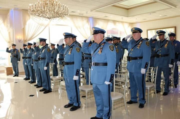 New Rochelle officers salute in honor of those who lost their lives in the line of duty. The police department recently held ceremonies that also recognized the accomplishments of nearly 100 of its members.
