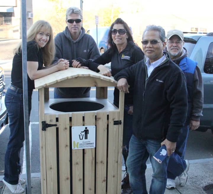 Taking a break from installing the new trash can corrals in Nanuet recently are, from left: Chamber president Risa Hoag, member Nicholas Miller, who made the corrals; Chamber secretary Susan Farese, member George Mollo and past president Tim Chhim.
