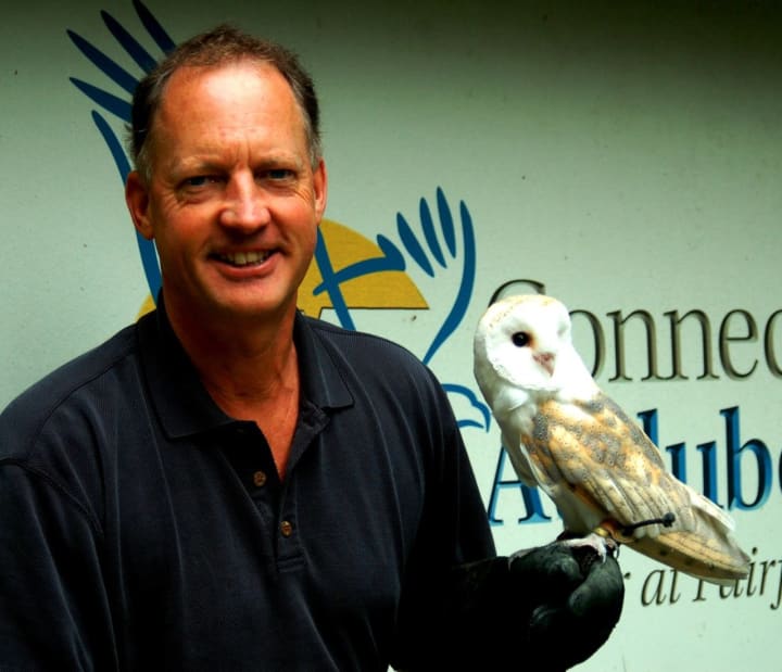 Alexander Brash, president of the Connecticut Audubon Society, with a barn owl.