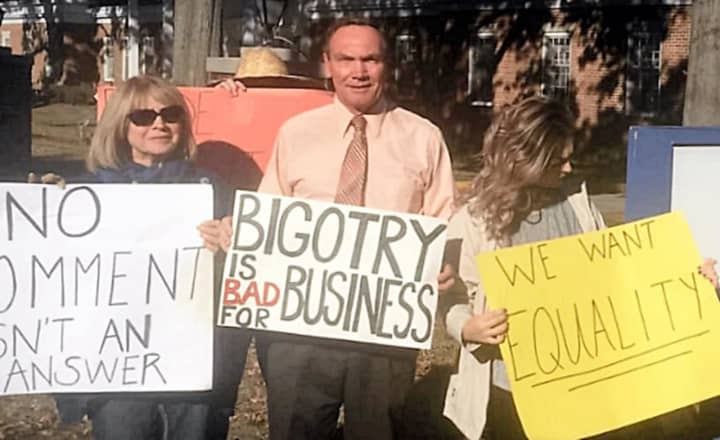 New Milford Councilwoman Hedy Grant, left, and Assemblyman Tim Eustace were joined by others in Oradell on Friday in protesting Affinity Credit Union&#x27;s support of U.S. Rep. Scott Garrett.