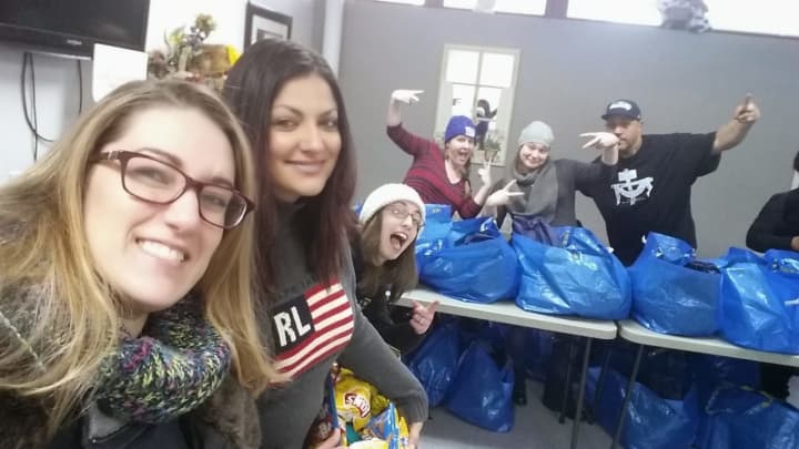 Nikki Whitney (left) and her team pack personal items into bags to distribute to the homeless.