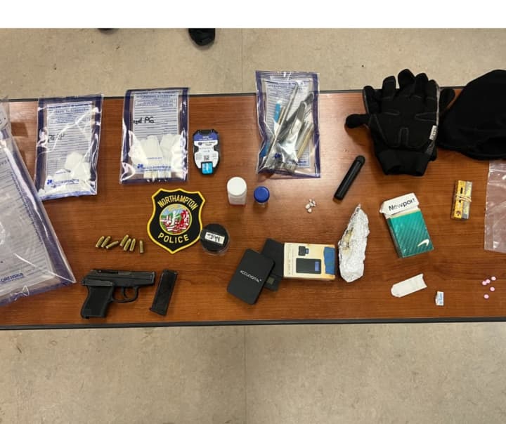 Northampton police found drugs and a gun inside a car where two men were fast asleep in the middle of the road, authorities said.