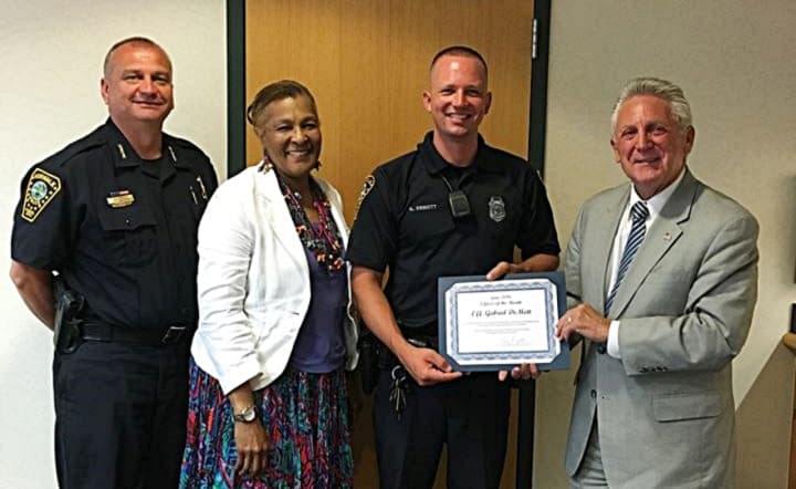 (from left) Police Chief Thomas Kulhawik, Commissioner Fran Collier-Clemmons, Officer Gabe DeMott and Mayor Harry Rilling