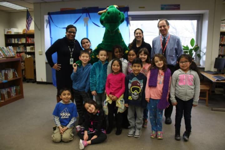 Oakside Elementary School students pose with Fidelis Insurance Company&#x27;s trademark Fidelis dinosaur during the school&#x27;s first annual Dental Health Fair on Feb. 25.