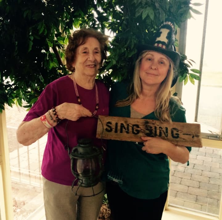 Ossining Village Historian Dana White,  right,  and Cedar Manor Nursing and Rehabilitation Center resident Ellen Polidoro, left, pose with some artifacts from the Ossining Historical Society Museum.