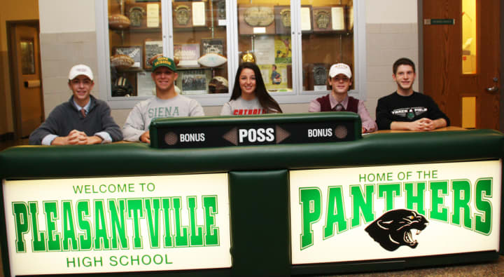 Five Pleasantville High School athletes who committed to playing a sport in college sign letters of intent.