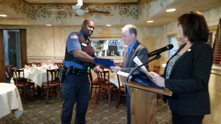 Ramapo Police Officer Wayne Mitchell accepts congratulations from County Executive Ed Day at the Stop-DWI Awards Luncheon.