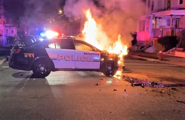 Paterson police car in flames.
