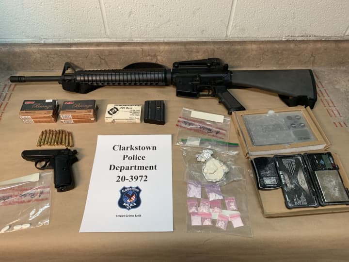 The guns and drugs seized during the search.