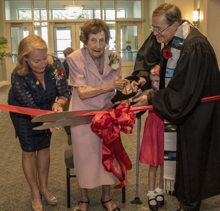 Ribbon Cutting Ceremony for NPC&#x27;s Rededication. Participating: Jean Ann Bolman (Building Committee Vice Chair), Maude Pettus (oldest member at 101), Anna Keehlwetter (best Sunday school 1st grade attendance) and Senior Pastor Sam Schreiner. 
