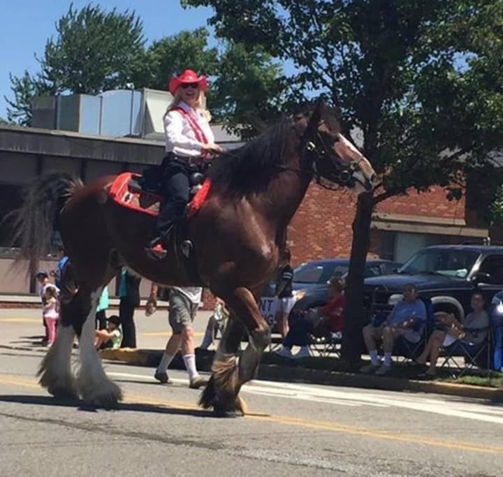 Stuntwoman and Elmwood Park native Diane Peterson rides a horse in the borough&#x27;s Centennial Parade on Sunday.