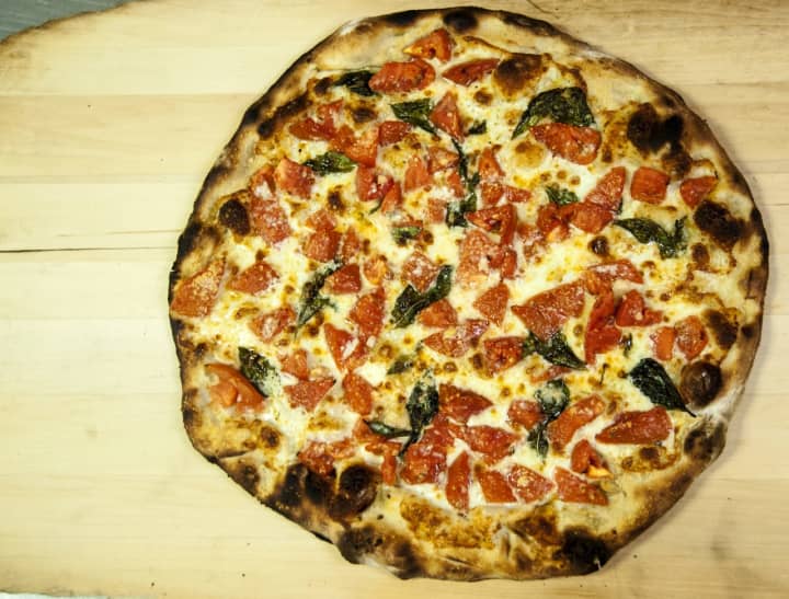 Frank Pepe Pizzeria Napoletana Fresh Tomato Pie is back on the menu at the restaurants this summer.