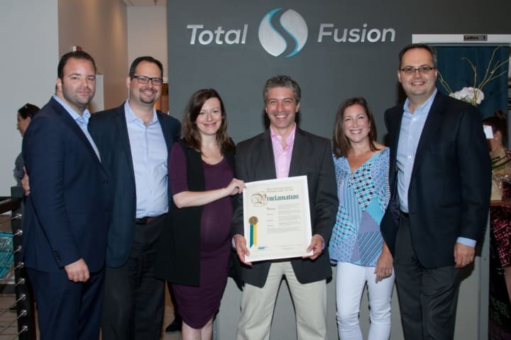Mitchell Slavuter, Richard Bayer, Sasha Bayer, Dr. Dima Teitelman, Stacy Bayer, Alex Bayer hold proclamation at grand opening event of TotalFusion in Harrison.