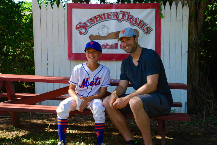 Neil Walker poses with a camper at Summer Trails in Somers.