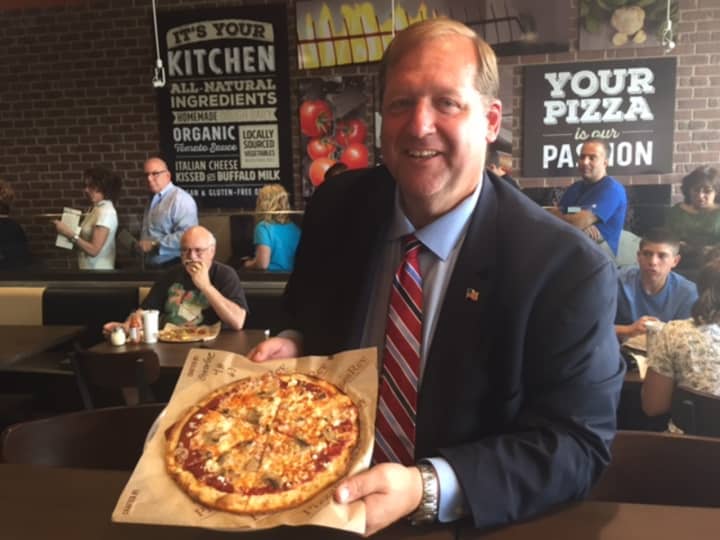 Clarkstown Supervisor George Hoehmann with his pizza at PizzaRev.