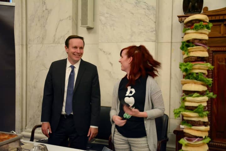 U.S. Sen. Chris Murphy checks out the stack of burgers at the Plan B table at the Discover CT event in Washington, D.C.