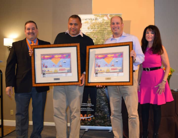 Emcee Mike Stacy helps present Tom Patterson and Lee Carney the Mission Champion award, with the president of the Connecticut Chapter of the National Multiple Sclerosis Society, Lisa Gerrol, at the chapter&#x27;s annual meeting on March 6.
