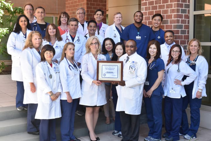 Valley’s Respiratory Care department poses, with Bettyann Kempin, Assistant Vice President, Medical/Surgical Services, and Jean-Herve Mondestin, Director, Respiratory Care Services and the Center for Sleep Medicine shown holding the plaque.