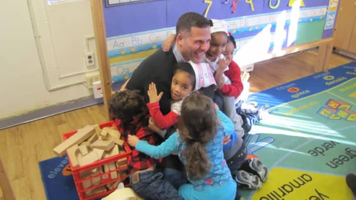 Dutchess County Executive Marcus Molinaro reading to students at The Catharine Street Center during the 2016 event.