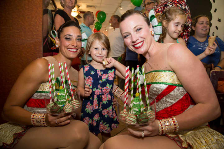Rockettes pose with a young fan at Main Street Sweets.