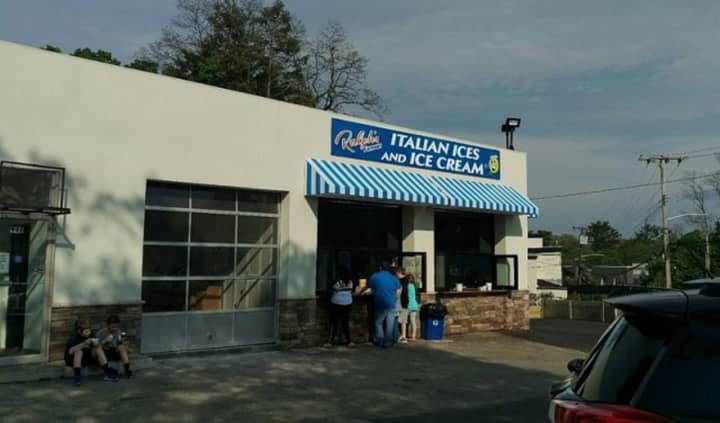Customers belly up to the take-out window at Ralph&#x27;s Italian Ices and Ice Cream in Mamaroneck to get cold treats on a hot summer day. Neighbors are complaining about the noise, traffic and trash the shop generates.