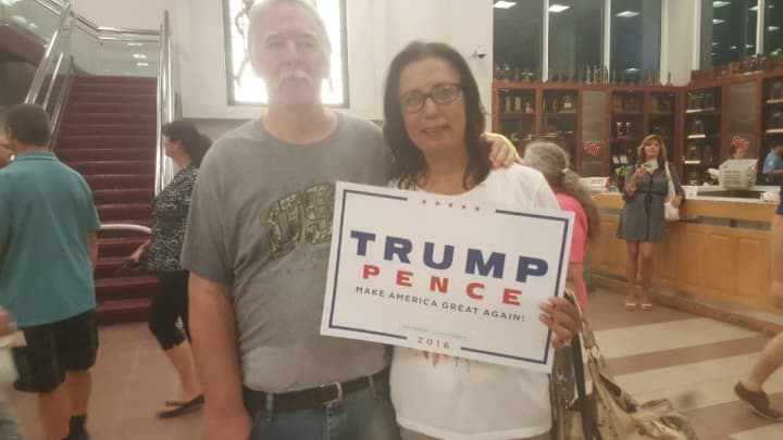 John and Millie Pitzschler of Putnam show off their Trump-Pence sign after the rally at Sacred Heart University.