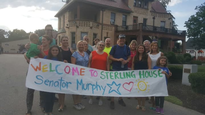 A crowd greets U.S. Sen. Chris Murphy as he arrives late Thursday afternoon at the Sterling House Community Center in Stratford.