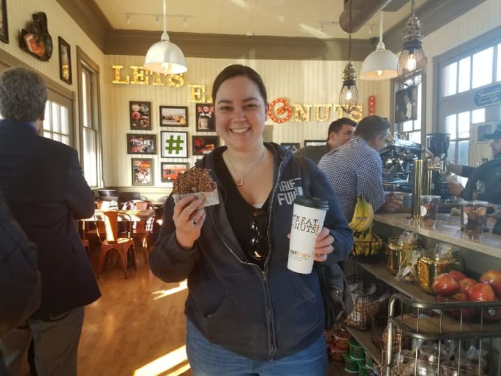 Gabby Jordan of Stamford enjoys a Nutella doughnut on the opening day of Donut Crazy at the Westport Train Station on Friday.